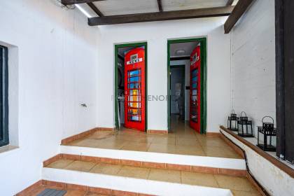 Local comercial en venta con terraza y vivienda en la parte superior.